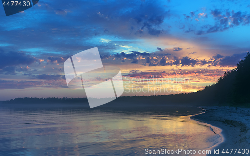 Image of Amazing Sunset Over The Forested Shore Of The Northern Lake