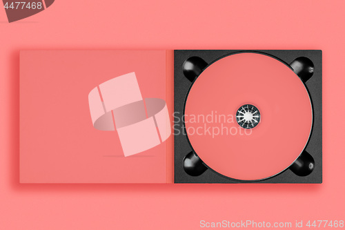 Image of pastel pink cd in case on pastel pink background.