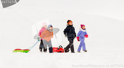 Image of happy little kids with sleds in winter