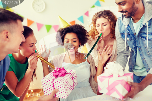 Image of team greeting colleague at office birthday party