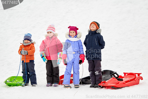 Image of happy little kids with sleds in winter