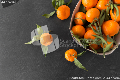 Image of close up of mandarins on slate table top