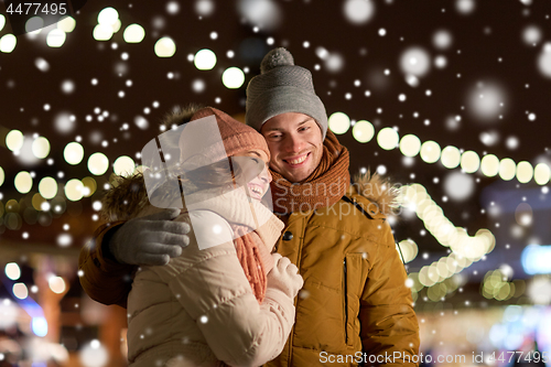 Image of happy couple hugging at christmas tree