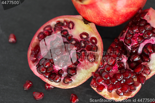 Image of close up of pomegranate on stone table