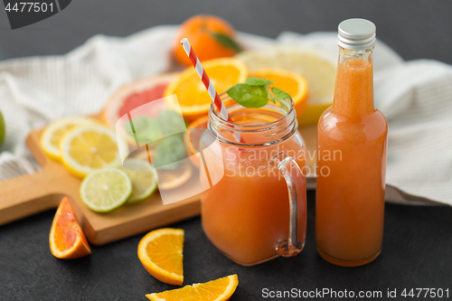 Image of mason jar glass of fruit juice on slate table top