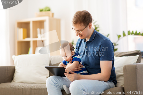 Image of happy father and baby son with tablet pc at home