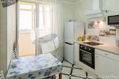 Image of The interior of a small kitchen with a balcony