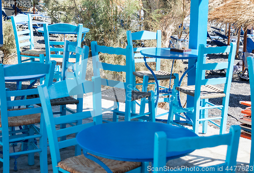 Image of restaurant terrace in front of the beach in kamari on the island