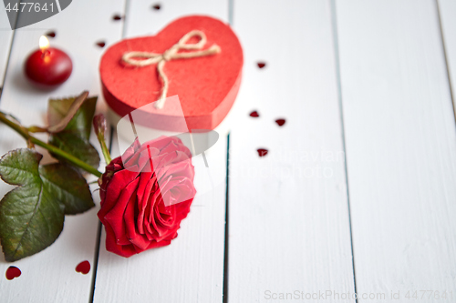 Image of Fresh red rose flower on the white wooden table