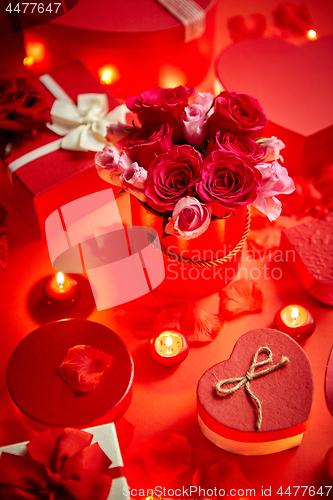 Image of Valentines day romantic decoration with roses, boxed gifts, candles