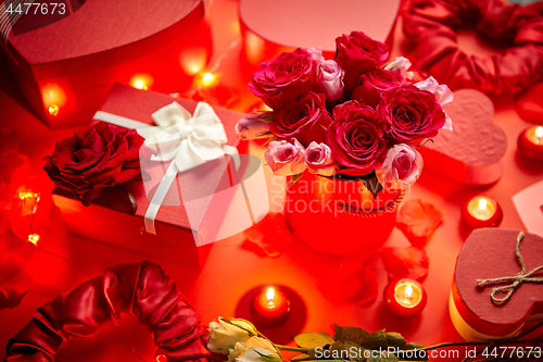 Image of Valentines day romantic decoration with roses, boxed gifts, candles