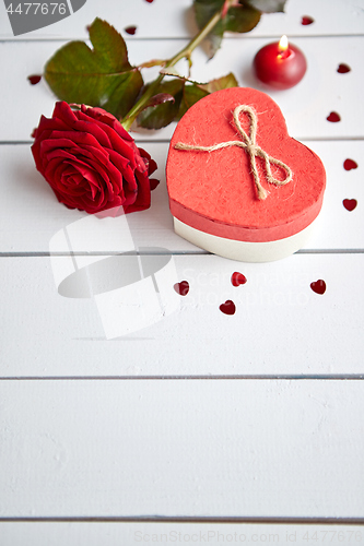 Image of Fresh red rose flower on the white wooden table