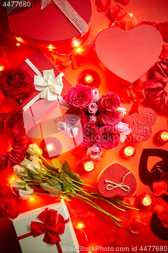 Image of Valentines day romantic decoration with roses, boxed gifts, candles