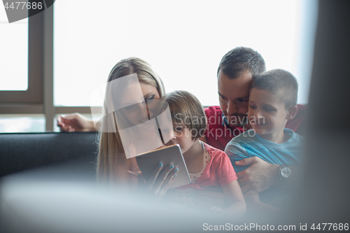 Image of happy young couple spending time with kids