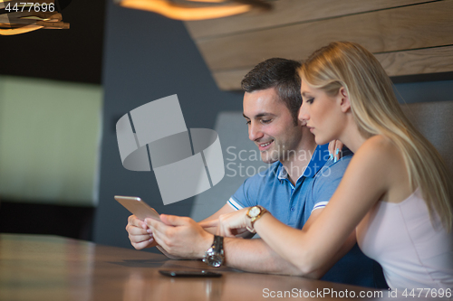 Image of couple using tablet at home