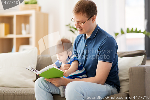 Image of happy father and little baby son with book at home