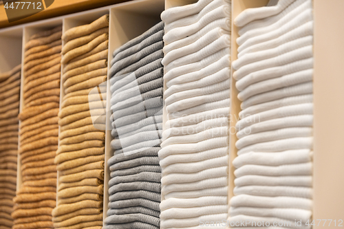 Image of close up of shelves with clothes at clothing store