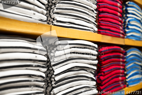 Image of close up of shelves with clothes at clothing store