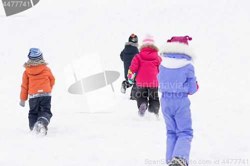 Image of happy little kids playing outdoors in winter