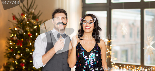 Image of couple with party props having fun on christmas