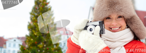 Image of woman with camera over christmas tree in tallinn