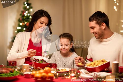 Image of happy family having christmas dinner at home