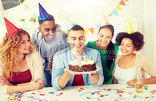 Image of team greeting colleague at office birthday party