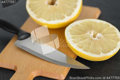 Image of close up of lemon and knife on cutting board