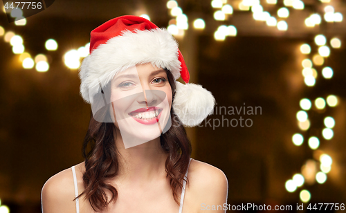 Image of woman with red lipstick in santa hat on christmas