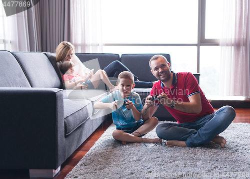 Image of Happy family playing a video game