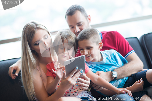 Image of happy young couple spending time with kids