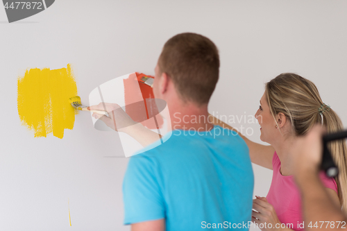 Image of couple painting interior wall