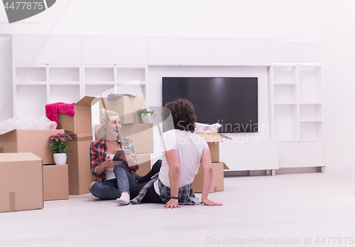 Image of young couple moving  in new house