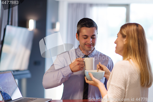 Image of A young couple is preparing for a job and using a laptop