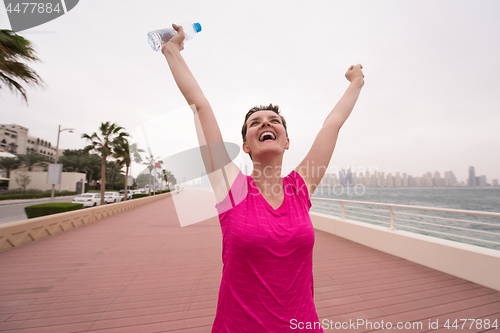 Image of young woman celebrating a successful training run