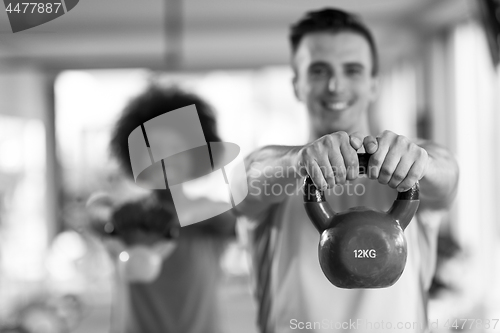 Image of couple  workout with weights at  crossfit gym