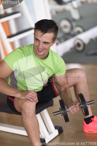 Image of handsome man working out with dumbbells