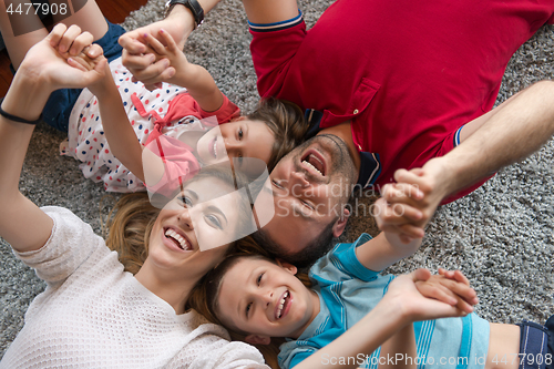 Image of happy family lying on the floor