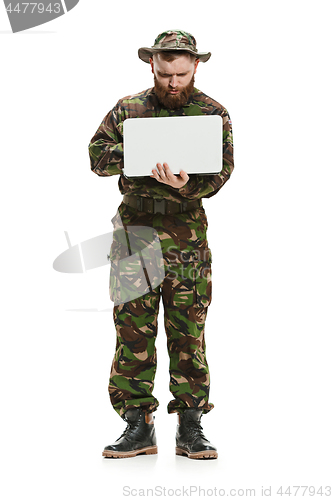 Image of Young army soldier wearing camouflage uniform isolated on white