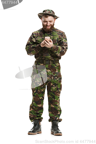 Image of Young army soldier wearing camouflage uniform isolated on white