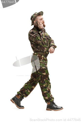 Image of Young army soldier wearing camouflage uniform isolated on white