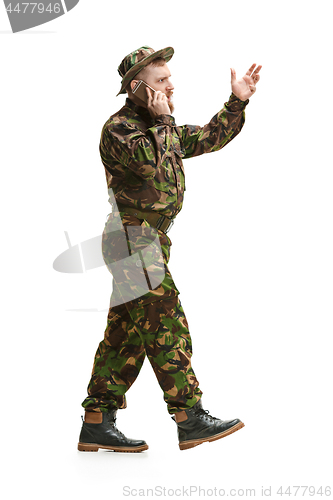 Image of Young army soldier wearing camouflage uniform isolated on white