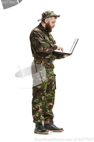 Image of Young army soldier wearing camouflage uniform isolated on white