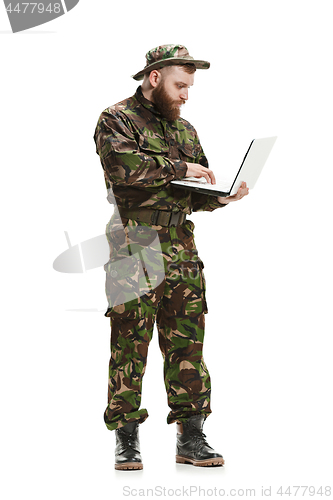 Image of Young army soldier wearing camouflage uniform isolated on white