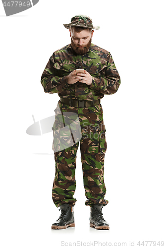 Image of Young army soldier wearing camouflage uniform isolated on white