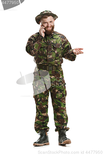 Image of Young army soldier wearing camouflage uniform isolated on white