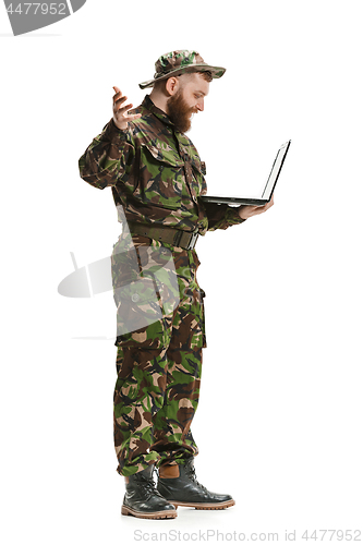 Image of Young army soldier wearing camouflage uniform isolated on white