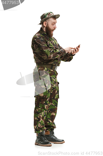 Image of Young army soldier wearing camouflage uniform isolated on white