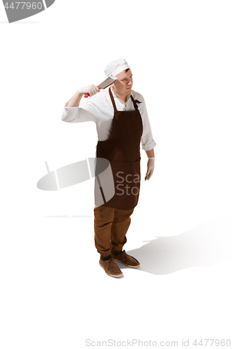 Image of Serious butcher posing with a cleaver isolated on white background