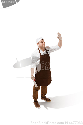 Image of Smiling butcher jumping with a cleaver isolated on white background